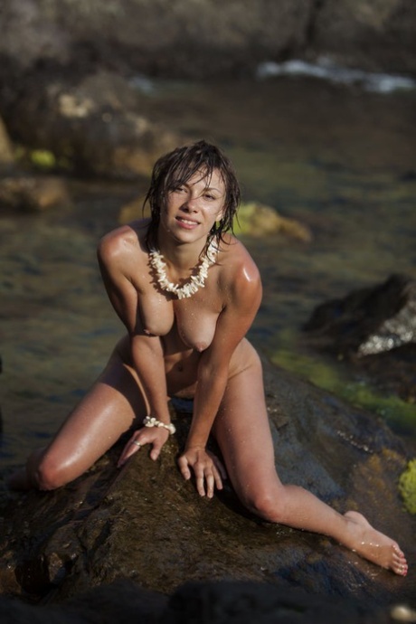 Naked teen Eddison finger fucks while on a rock in the water 13644616
