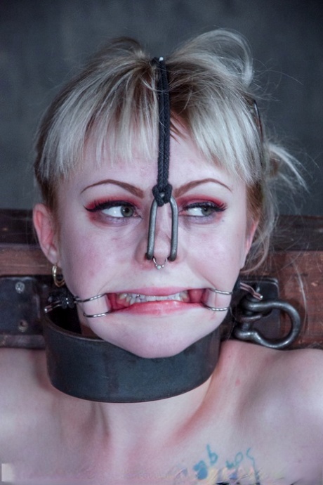 Blonde girl Anna Tyler grimaces in pain while being tortured in a dungeon 59636960