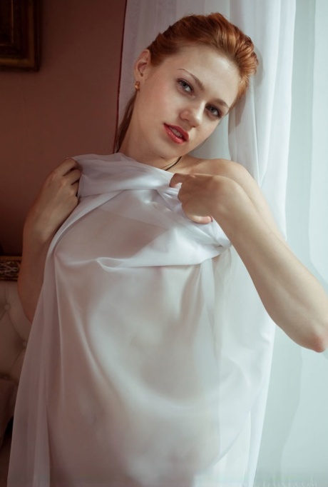Pale redhead Shirley Tate displays her sweet pussy after disrobing on her bed 50222889