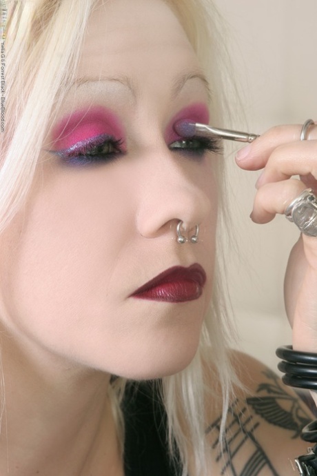 Tattooed blonde rocker Cindy B does her makeup while wearing a strapon cock 79169924