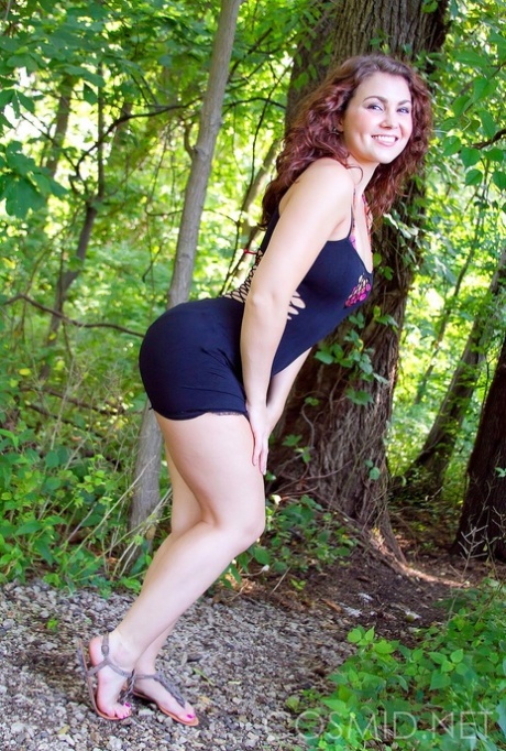 Curvy sexy girl slips out of her tight dress to show her tits in the woods 49787636