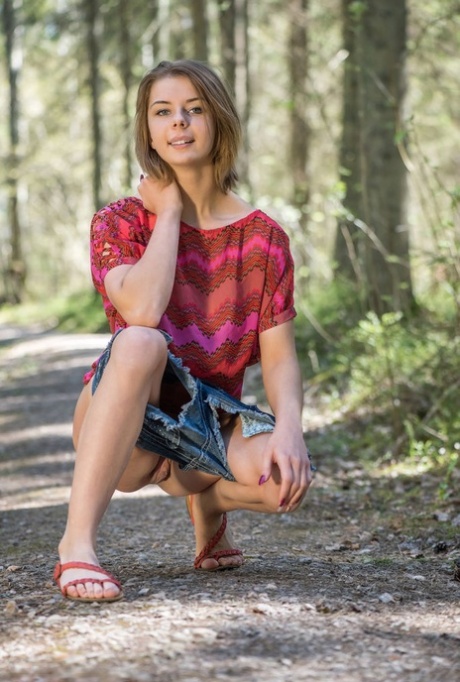 Teen girl uncovers her big natural tits and bald twat on hiking trail in woods 20631192