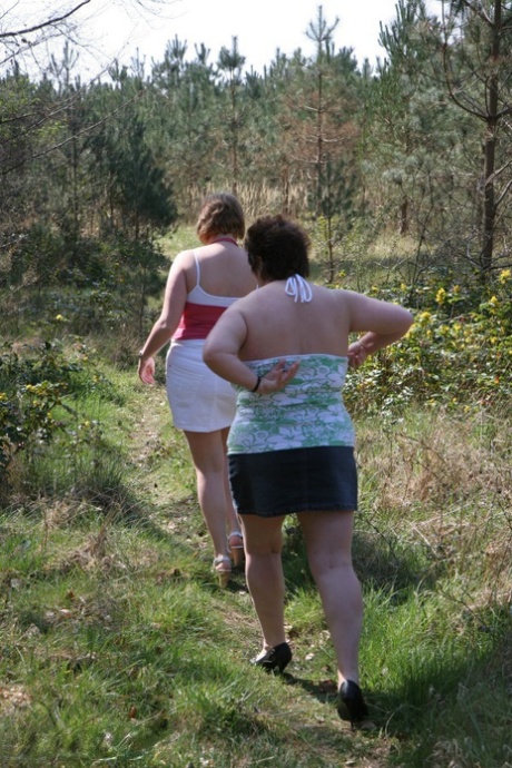 Older lady Kinky Carol and her girlfriend expose their large tits near trees 84660293