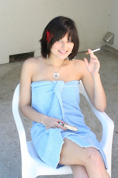 Brunette MILF Ellie Idol frees her naked body from bath towel while smoking 98263875
