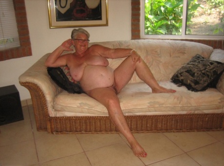 Old amateur Girdle Goddess strips completely naked on her chesterfield 80931449