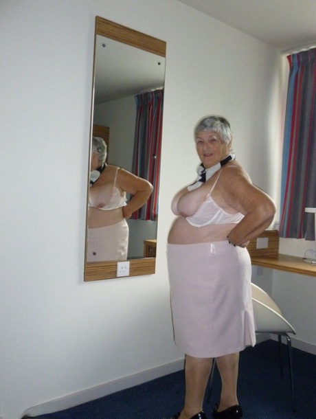 Obese old woman Grandma Libby lays her floppy tits on a desk while undressing 40661412