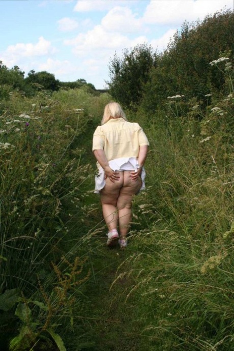 Older amateur Lexie Cummings holds her tits and then her huge ass in nature 78010605