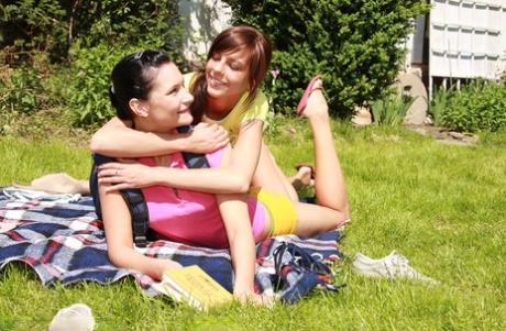 Young lesbians use vibrators during sex on a blanket in a backyard 96936436