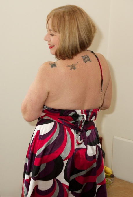 Older UK woman Speedy Bee slips off a dress to pose nude in tan stockings 37037065