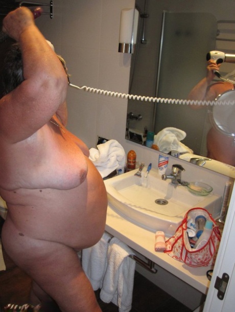 Obese amateur Grandma Libby blow drys her hair after taking a shower 94376629