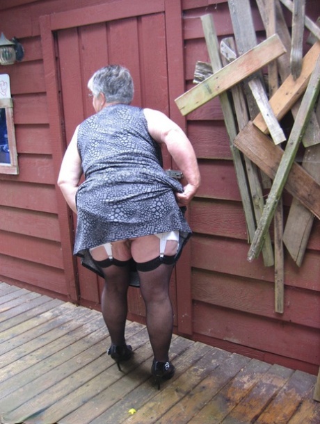 Fat oma Girdle Goddess unleashes her large boobs next to a boarded-up building 62662410