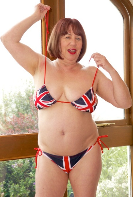 Older UK redhead Speedy Bee doffs a Union Jack bikini to get naked 87959015