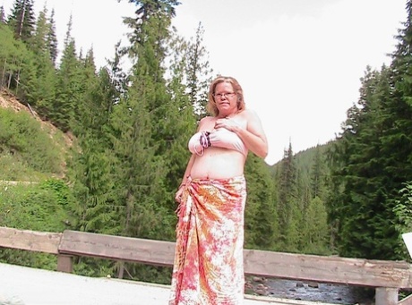 Busty granny Misha MILF exposes herself while on a bridge over top of a river 66041985