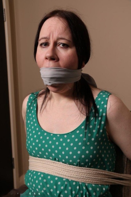 Distressed mature woman in polka-dot dress tied up & gagged for BDSM fun 14576344