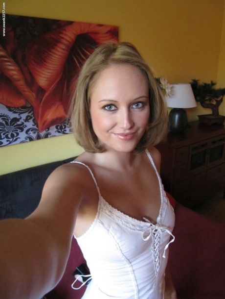 Amateur blonde takes self shots of her tan lined breasts as she gets undressed 72947006