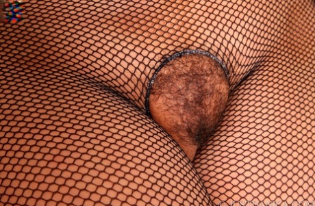 Busty mature lady Danica Collins pulls down her underwear in crotchless hose 56909791