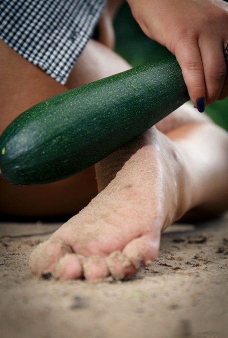 Young brunette Lola Ash pleasures her pussy with a cucumber on a dirt road 80507261