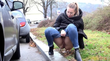 Blonde chick Nikki Dream squats for a pee behind vehicles on a road 71272275