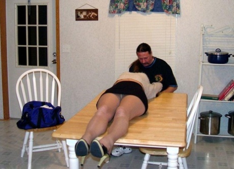 Brunette woman is tied up with rope on a table before having her boobs groped 49712473
