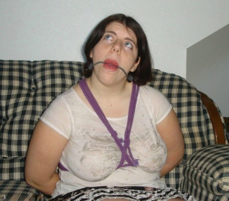 Overweight girl has her hands tied behind her back while her ankles are bound 91317332