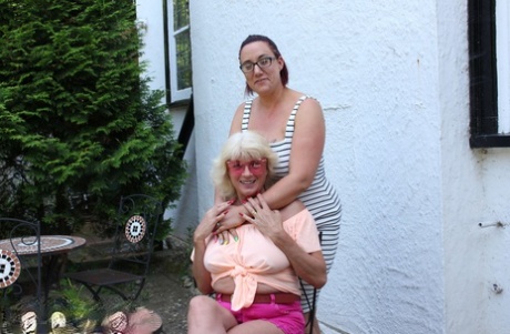 Older fatties pleasure each others lesbian pussies with sex toys on a bed 81052729