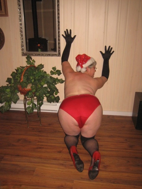 Old amateur Girdle Goddess strips off her attire while wearing a Christmas hat 83987818