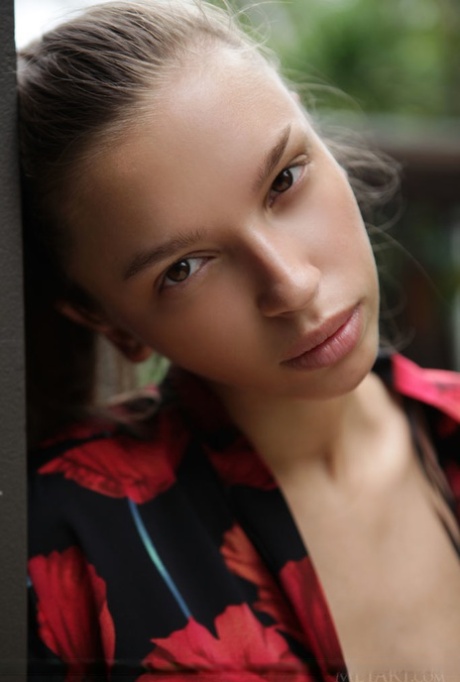Slim teen Elin casts sultry looks while modeling naked on a deck 75202842