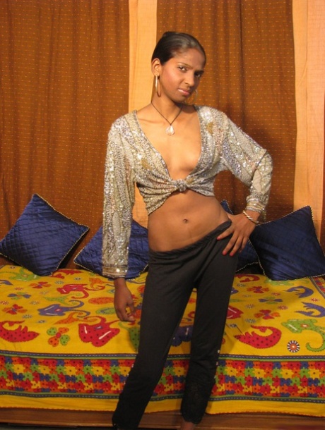 Indian MILF unveils her firm breasts during solo action on a bed 13184042
