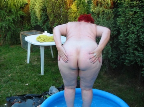 Older redheaded BBW Valgasmic Exposed plays with a dildo in a wading pool 35513020