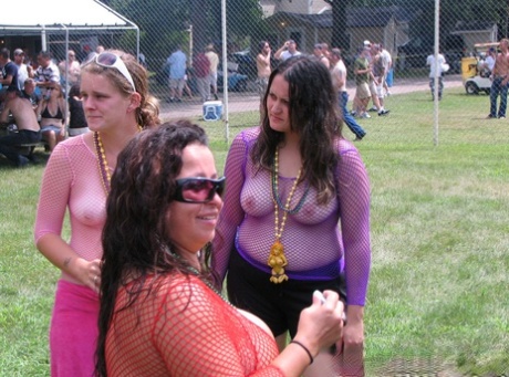 Amateur girls get naked during a strip show at a clothing optional club