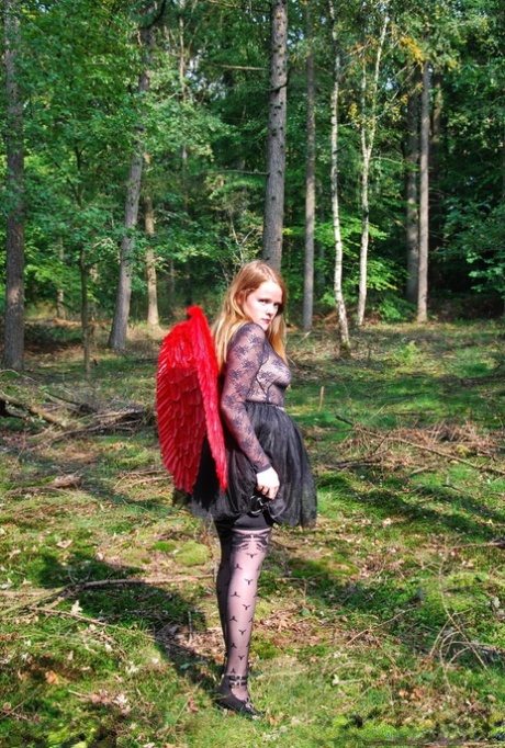 Amateur solo girl sports angel wings while modelling lingerie on a tree stump 49846744