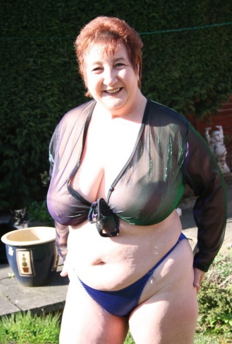 Mature redhead BBW Kinky Carol sets her huge boobs free in the yard 72780752
