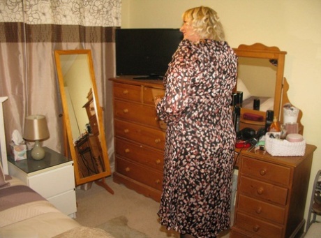 Older blonde fatty Chrissy Uk parts her labia lips on a chair in her bedroom 90220900
