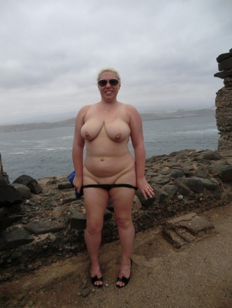 Mature amateur Barby gets totally naked in shades at a coastal location 84593089