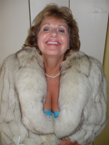 Mature amateur Busty Bliss exposes her tan lined tits while wearing a fur coat 18367047