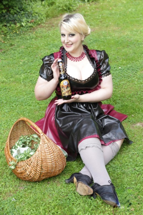 Overweight blonde Darkwing Zero models on a lawn in a rubber dress 13823767