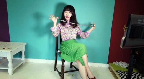 Close Asian chick removes ankle cuffs after being chained to a chair 15423572