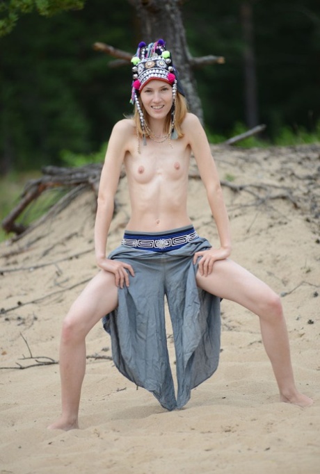 Skinny young girl Shanty A gets totally naked on driftwood at the beach 45465923
