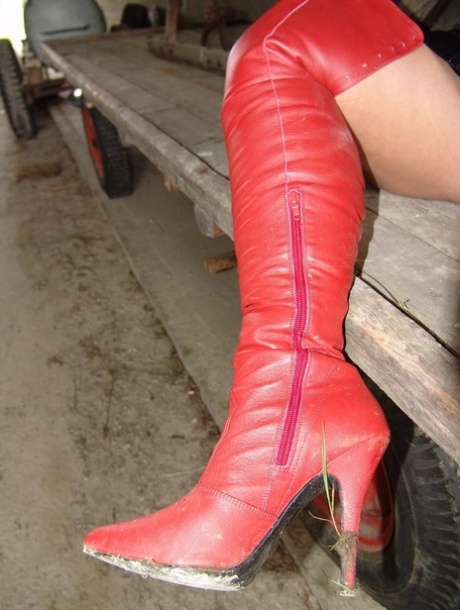 Goth girl Lady Angelina poses in latex clothing inside a farm storage building 45413165