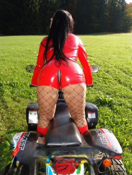 Goth woman Lady Angelina exposes her big tits in front of a four wheeler 98632256