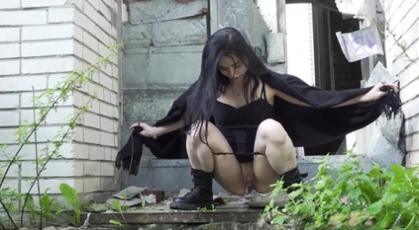 Dark haired chick Alyona sports a cape while taking an outdoor piss 42390051