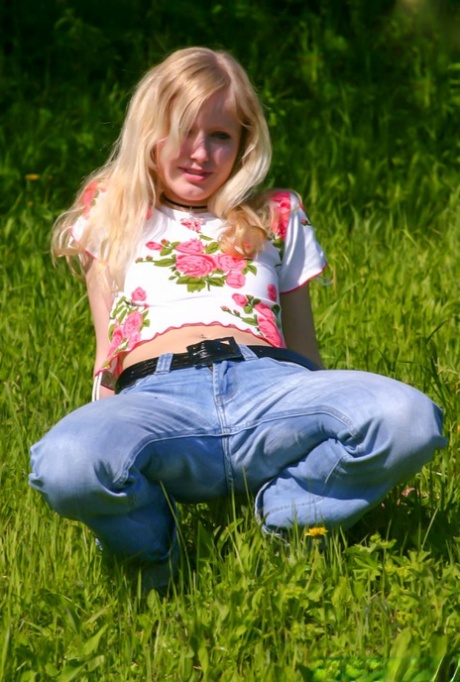 Barely legal blonde Yana F goes topless in panties on a patch of green 30373647