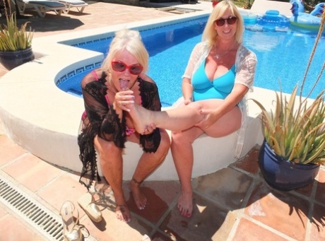 Mature blonde fatty Melody and her lesbian lover have foot play near a pool 67311604