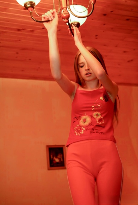 18-year-old redhead Avril A goes topless on a bed in capris 16561943