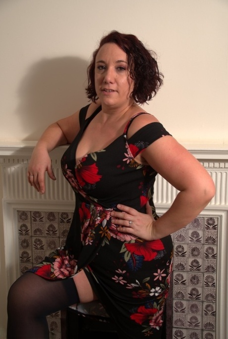 Mature lady discards her dress to model in her underthings and nylons 70567820
