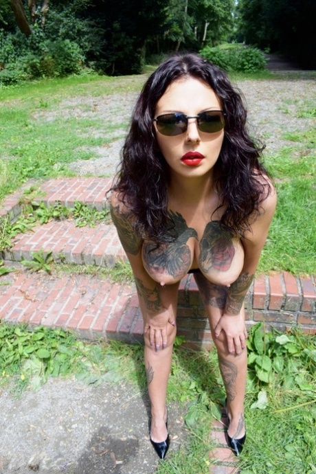 Tattooed brunette Lucy Ravenblood works her big tits and pussy free of a dress 87472494