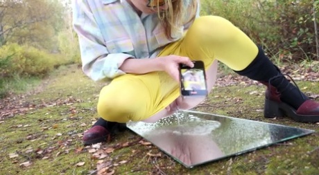 Blonde girl Squanch Baby pisses upon a mirror on a moss covered path 83939203