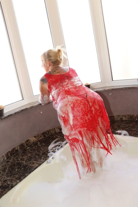 Older blonde fatty Melody partially removes a dress while taking a bubble bath 55231756