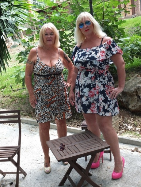 Fat older blonde Melody plays with her lesbian lover's boobs on a patio 18714428