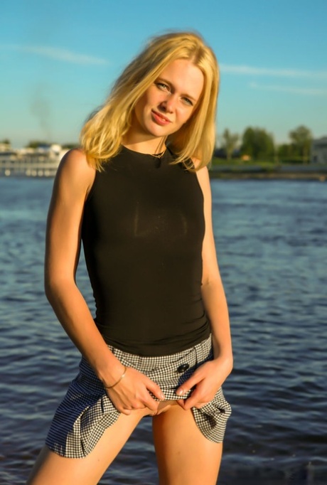 18-year-old blonde Petrina T steps into the water while showing her bald pussy 60532863